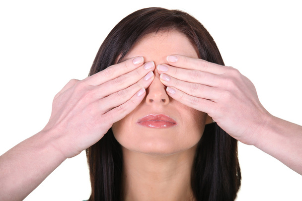 Woman with her hands over her eyes - Photo, Image