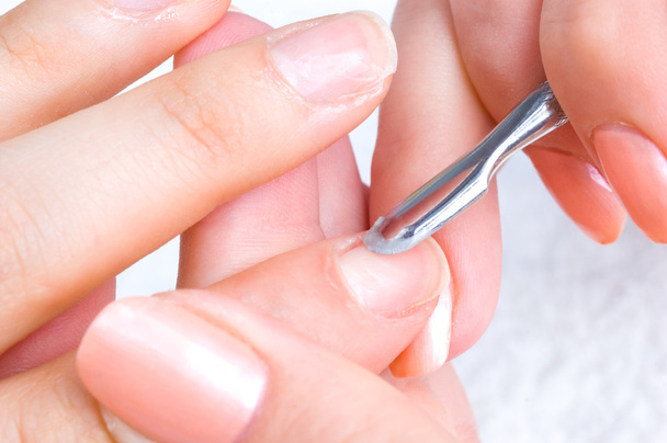 Manicure applying - cleaning the cuticles - 写真・画像