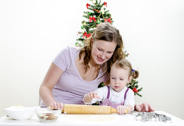 Little girl and mother are preparing Christmas cookies - Photo, Image