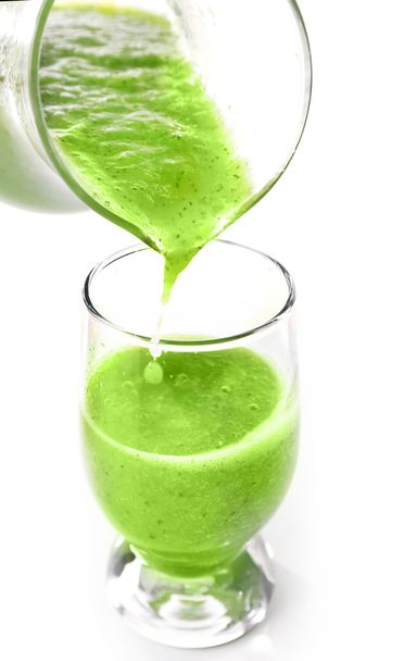 Pouring green healthy juice in glass isolated on white - Foto, afbeelding