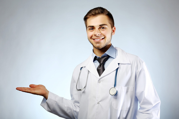 Male doctor with stethoscope on blue background - Fotoğraf, Görsel