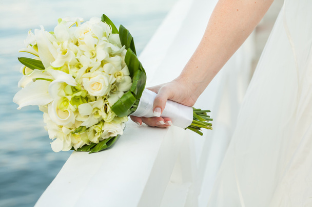 Bride is holding a wedding bouquet  - Zdjęcie, obraz