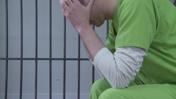 prisoner sitting in prison cell - Footage, Video