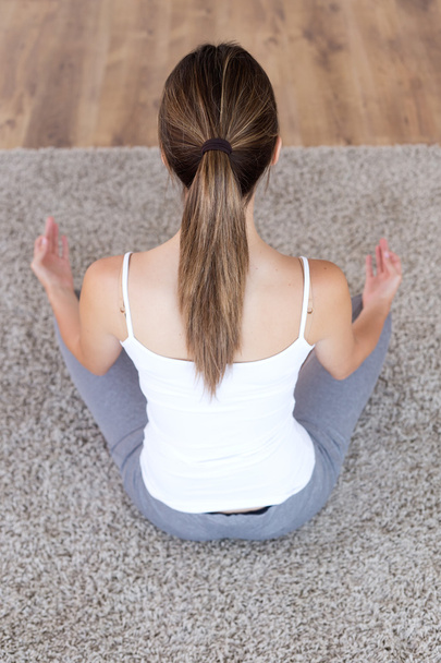 Beautiful young woman doing yoga exercises at home. - Zdjęcie, obraz