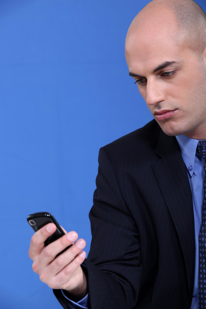 Businessman looking at his mobile phone - Photo, Image
