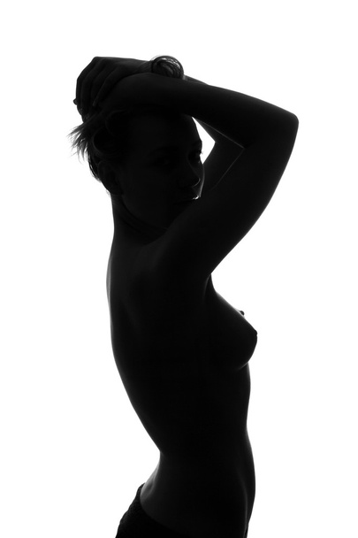 Silhouette of a sexy naked young woman. Isolated - Photo, Image