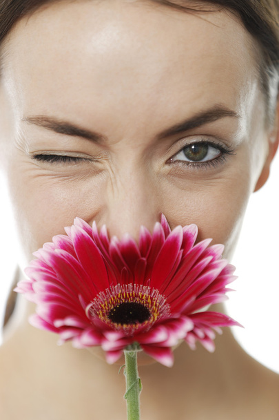 Woman smelling a red flower - Foto, immagini