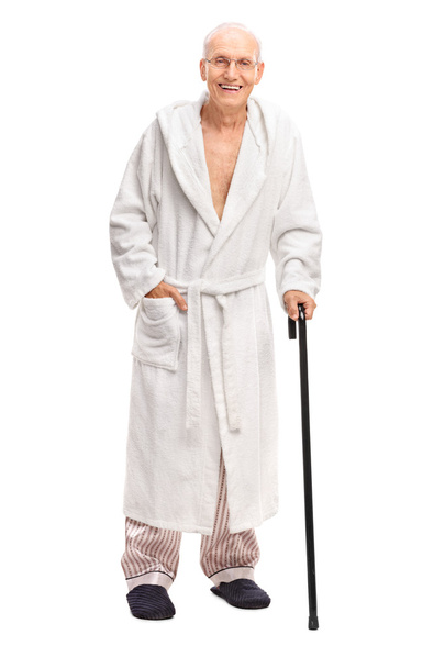 Senior man in a bathrobe holding a cane  - Foto, Imagem
