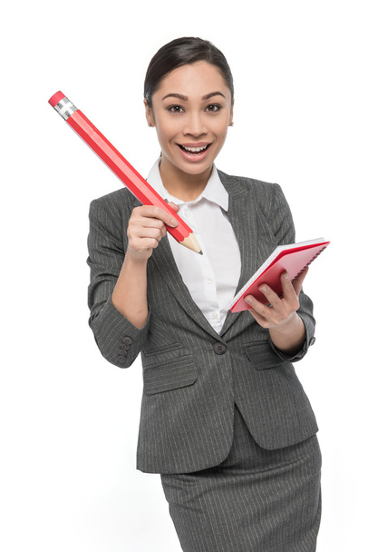 Happy Girl in Grey Suit with Giant Pencil And Pad Of Paper. - Foto, Imagem