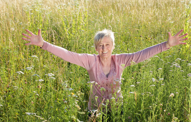 Happy senior woman active in nature - Фото, изображение