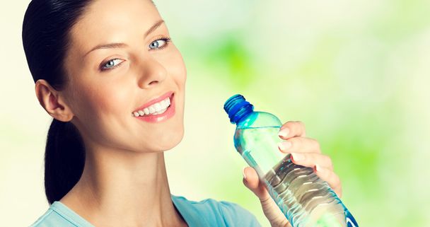 lovely woman with bottle of water - 写真・画像