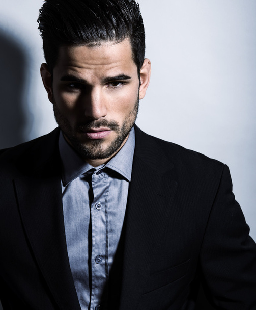 handsome young man in suit on grey background. Business man - Fotó, kép