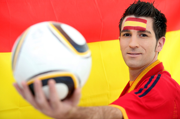 Male Spanish soccer supporter holding ball - Foto, imagen