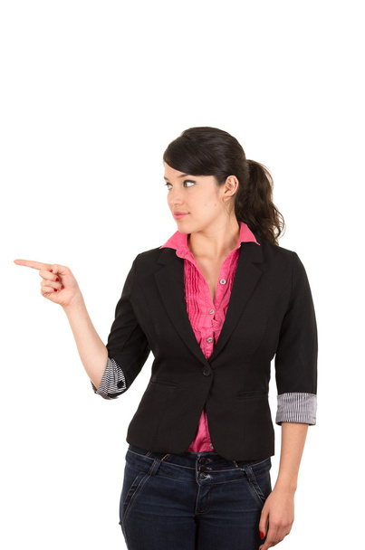 Hispanic woman in pink shirt and black blazer jacket pointing with right arm to the side looking same direction - Φωτογραφία, εικόνα