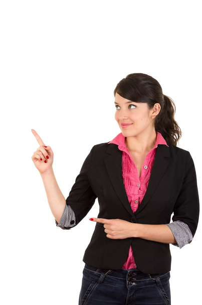 Hispanic woman in pink shirt and black blazer jacket pointing right hand upwards while left arm finger points same direction from hip, looking sideways - Фото, зображення