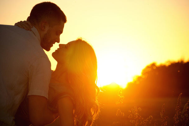 romantic sensual young couple in love kissing at the sunset - Fotó, kép
