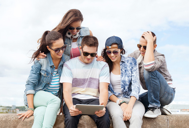 group of teenagers looking at tablet pc - Fotó, kép