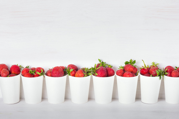 a series of white paper cups with fresh ripe delicious sweet str - Photo, Image