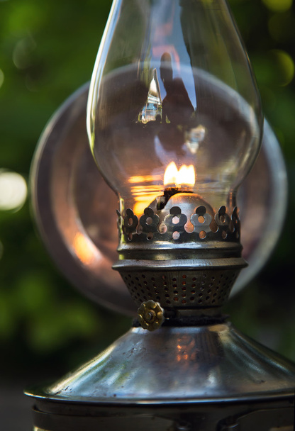 old kerosene lamp stands on the ground, outdoors - Fotografie, Obrázek