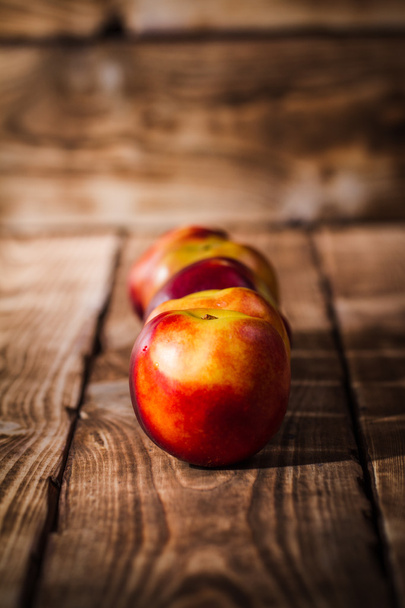 Peaches on a wooden background - Fotografie, Obrázek