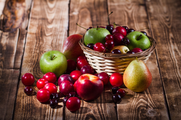 Fruits on the wooden background - Foto, Imagen