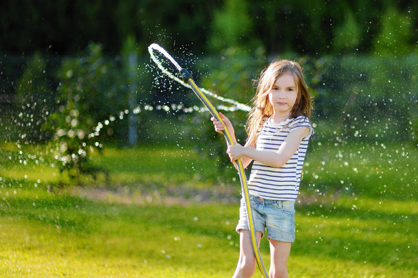 girl playing with a garden hose - Photo, image