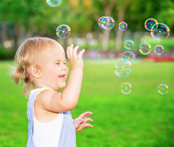 Happy child playing outdoors - Фото, изображение