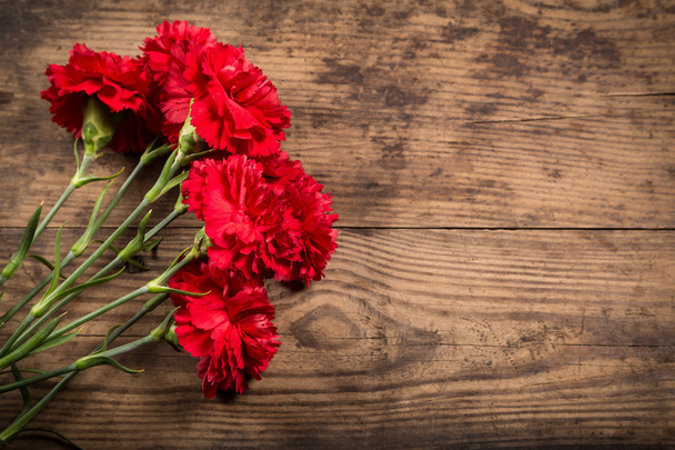 carnations on wooden background - Foto, Imagen