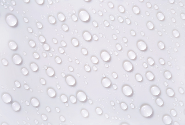Water drops on the white surface  - Photo, Image