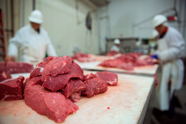 Stacked pile of red raw meat uncooked being cut and butchered - Photo, Image