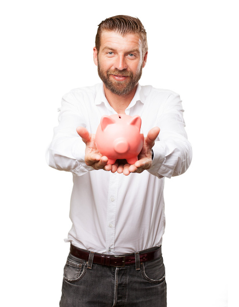 happy young man with piggy bank - 写真・画像