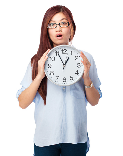 worried chinese woman with clock - Foto, immagini