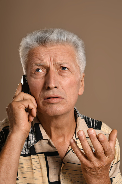 elderly man with phone - Fotó, kép