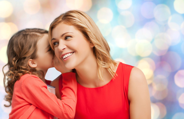 happy mother and girl whispering into ear - Foto, Bild