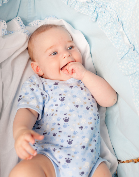 Smiling boy laying in his cradle - Zdjęcie, obraz
