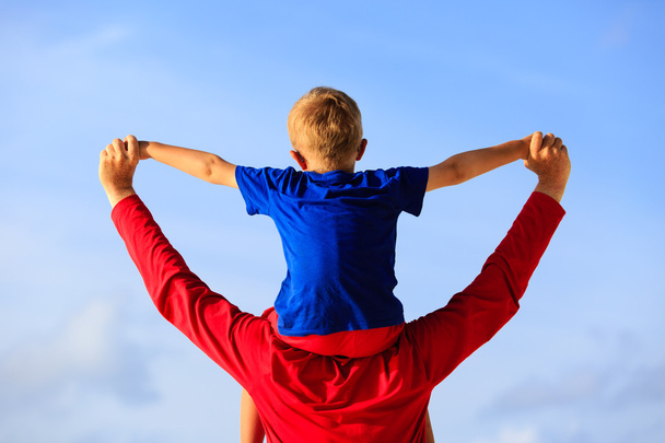 Gelukkig vader en zoontje spelen op sky - Foto, afbeelding