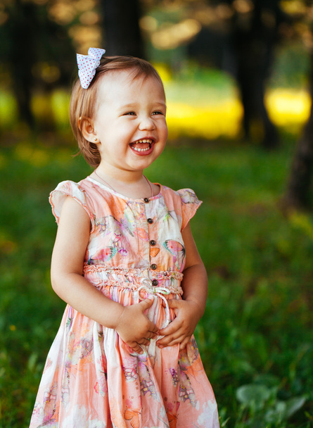 Outdoor portrait of adorable smiling little girl in summer day - Photo, Image