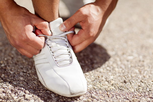 Man Tying His Shoes - Фото, изображение