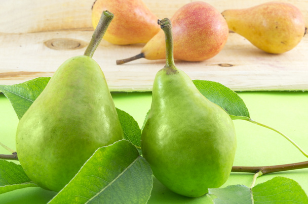 Vihreä päärynä ja päärynä haara puinen pöytä oranssi päärynät
  - Valokuva, kuva