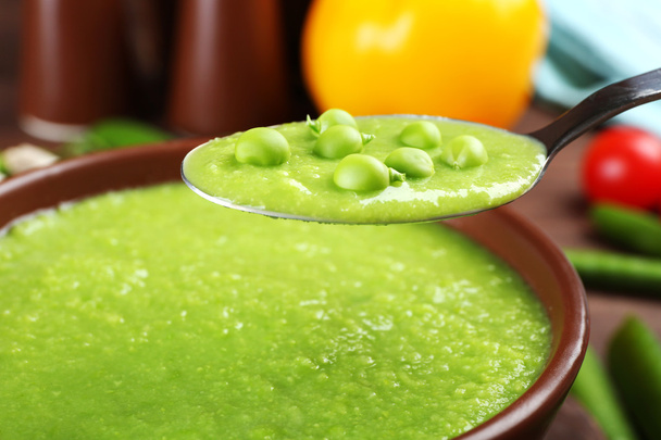 Tasty peas soup and vegetables on table close up - Fotó, kép