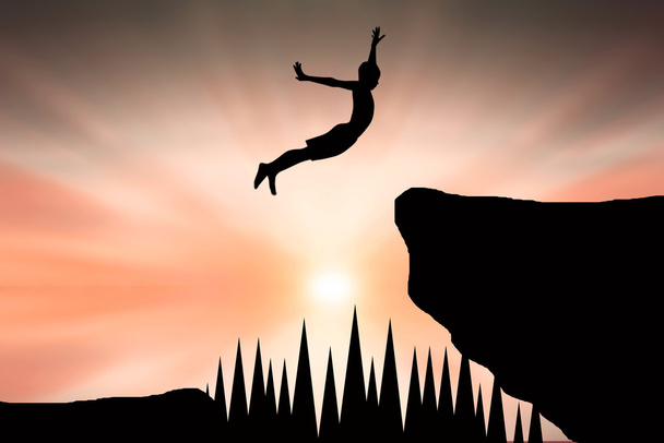 Sziluettjét ember átugrani a szikla - Fotó, kép