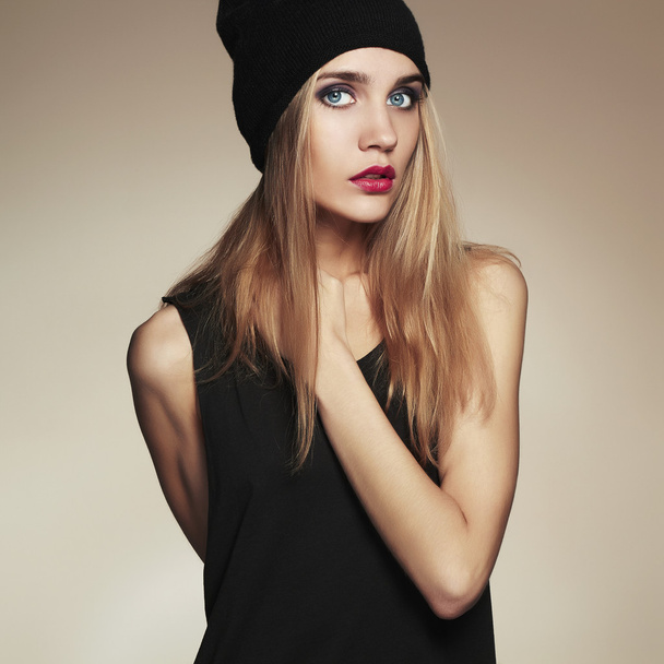 fashionable beautiful young woman in hat. beauty blond girl in cap. casual wear - 写真・画像