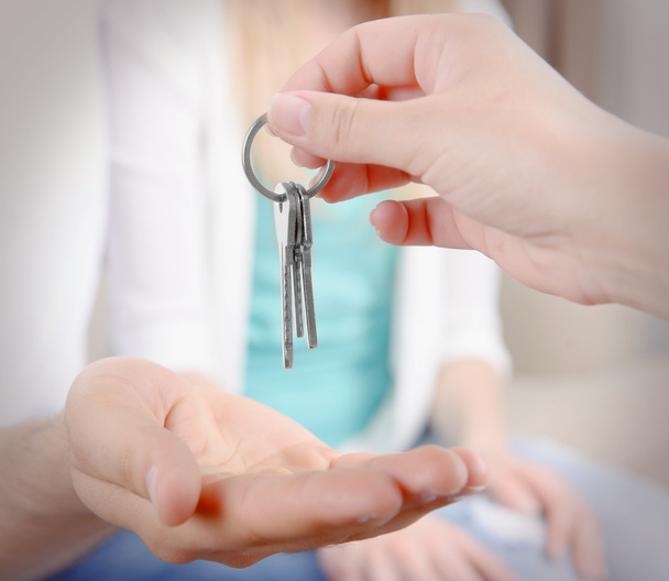 Real estate agent giving keys - Foto, afbeelding