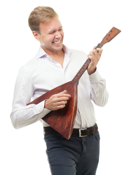 Excited young man playing balalaika, isolated on white - Foto, afbeelding
