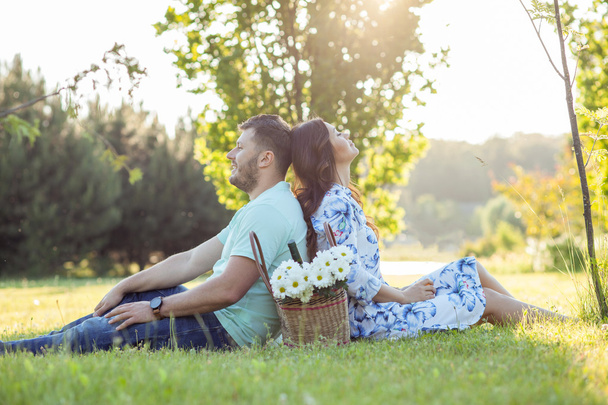 Cheerful young loving couple is relaxing in park - Foto, immagini