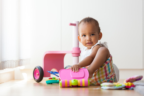 Portrait of little African American little girl sitting on the f - Photo, image