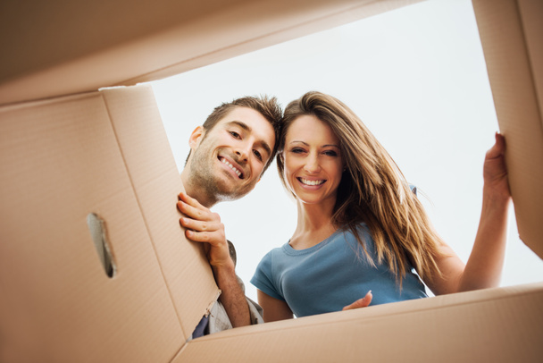 Happy couple opening a box - Photo, Image