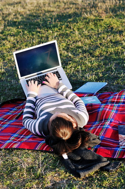 Young girl work on laptop outdoor - 写真・画像