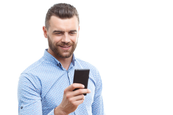 Handsome man with beard holding mobile phone  - Photo, Image
