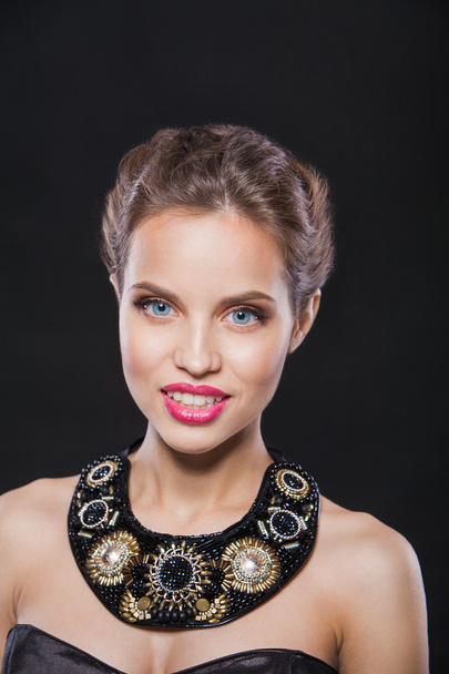 portrait of a beautiful smiling fashion model with gorgeous necklace.  - Fotó, kép